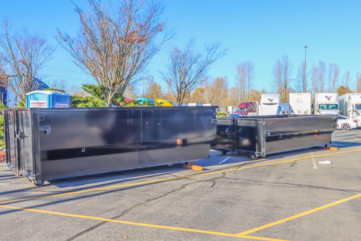 Professional dumpster rental service with roll-off container on residential driveway in Cocoa